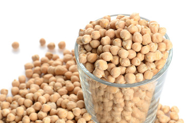full glass of chick peas isolated on white