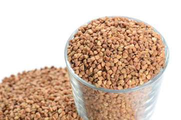 heap of buckwheat and glass isolated on white