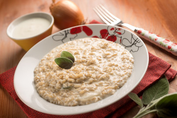 risotto with onion  cream sauce and sage, selective focus