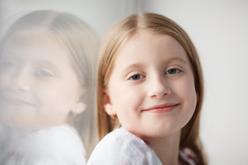 Little girl sitting on the windowsill