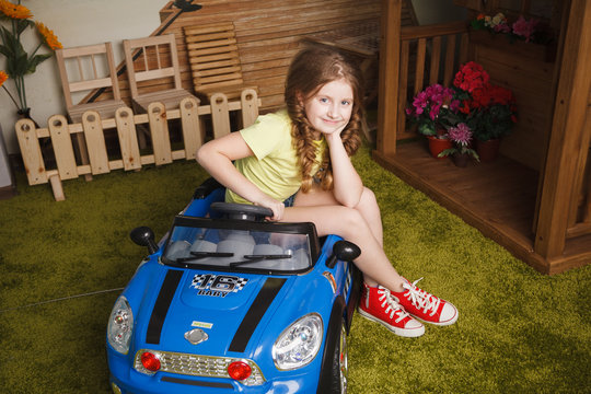 Little girl with tiy car