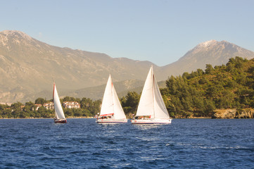Three boats on the background of the high mountains
