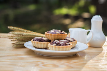 chocolate tart in dish on wood table.