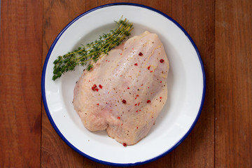 chicken on dish on brown wooden background