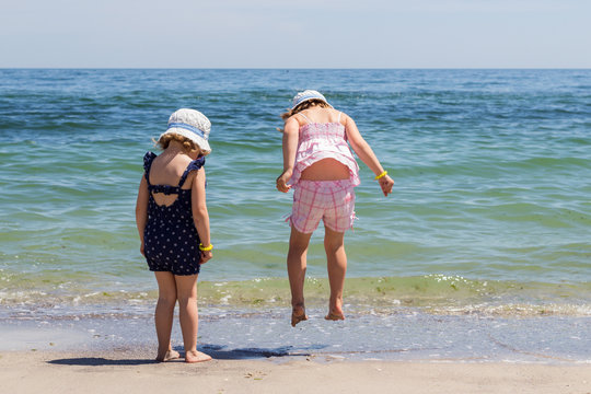Beautiful little girls (sisters) are running and playing on the