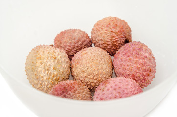 The lychee (Litchi chinensis) fruits in a transparent bowl