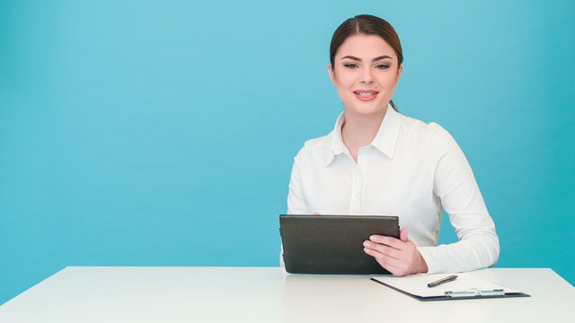 Beautiful girl tv newscaster reports with pretty smile