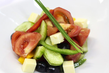 Delicious salad served in a white plate.