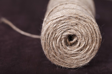 skein of twine on a brown background - obrazy, fototapety, plakaty