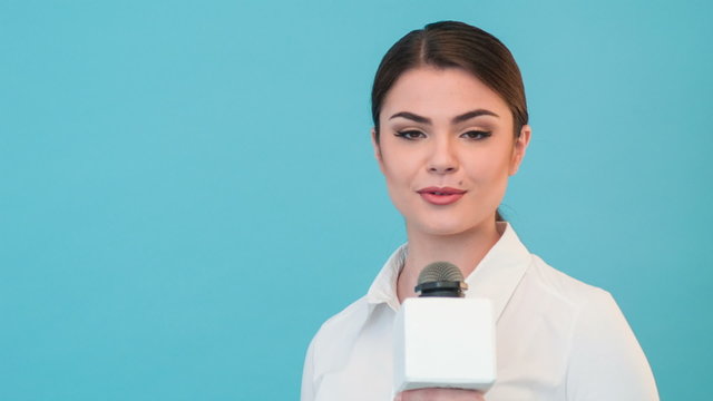 Beautiful girl TV journalist with pretty smile is reporting