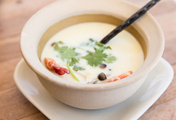bowl of creamy soup with shrimps on table
