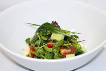 Delicious salad served in a white plate.