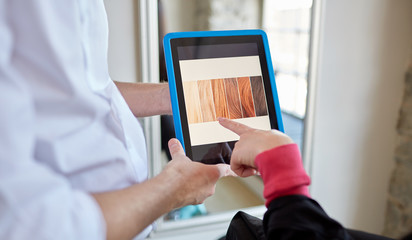 woman and stylist with tablet pc at beauty salon