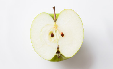 ripe green apple half over white