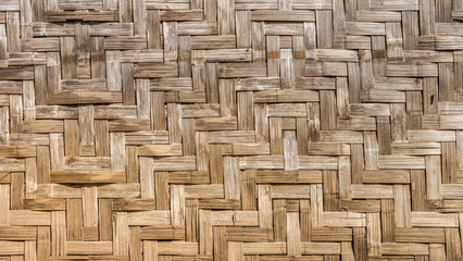 Natural traditional wooden wall is made by bamboo wickerwork
