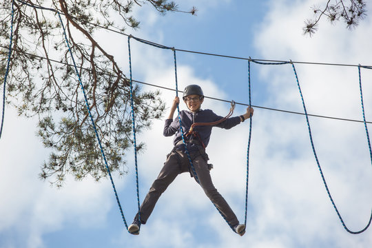 boy climbing in adventure park, rope park  