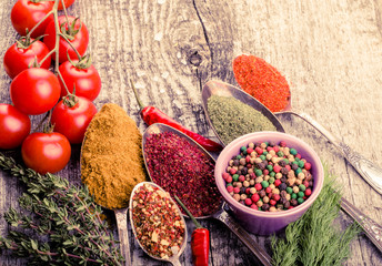 Bunch of cherry tomatoes, herbs, small bowl and antic metal spoo