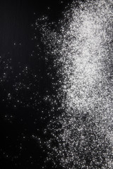 Flour on a black background. Culinary galaxy