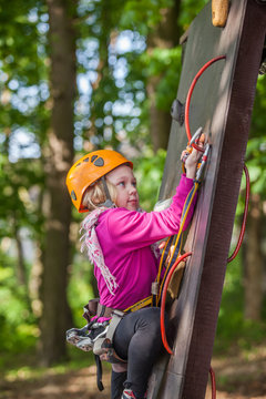 Girl climbing in adventure park , rope park  