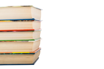 A stack of books in color covers isolated on white background. S
