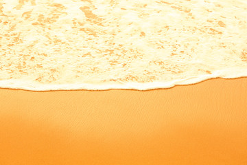 Sea foam on a sandy beach. Toned