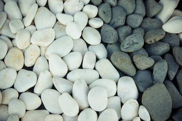 Background of black and white pebbles. Toned