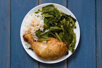 fried chicken with rice and kale on white plate