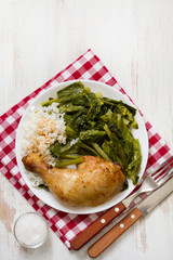 fried chicken with rice and vegetables on white plate