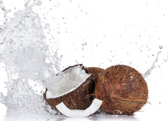 Cracked coconuts on white background