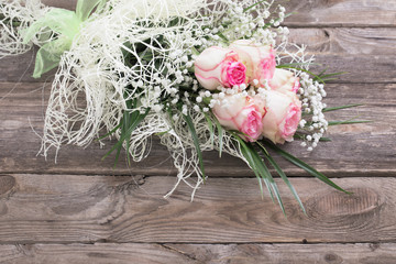 Bouquet of roses on old wooden board