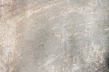 Gray cement wall with traces of the brush on the crumbling plast