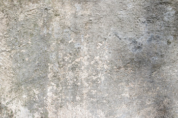 Gray cement wall with traces of the brush on the crumbling plast