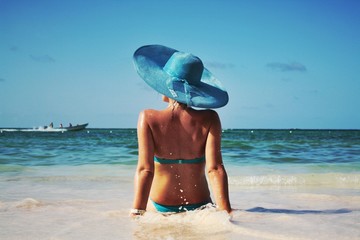 Fototapeta na wymiar Girl on the beach of Atlantic ocean