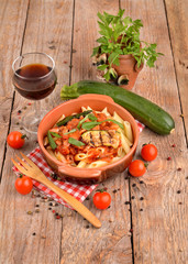 Penne with tomato sauce with bacon, zucchini and eggplants