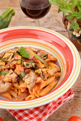 Penne with tomato sauce with bacon, zucchini and eggplants