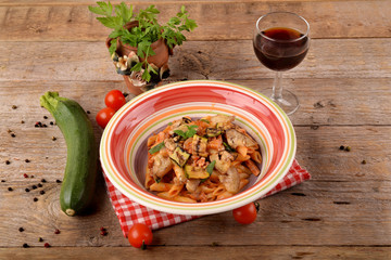 Penne with tomato sauce with bacon, zucchini and eggplants