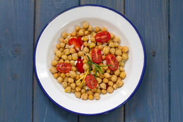 salad with chickpea and tomato on white plate