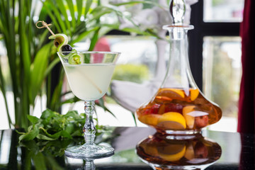 bright glasses with cold alcoholic cocktail on a table in a restaurant with creative decoration. soft focus