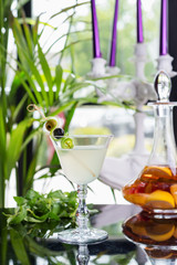 bright glasses with cold alcoholic cocktail on a table in a restaurant with creative decoration. soft focus
