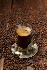 Coffee cup on coffee grains background