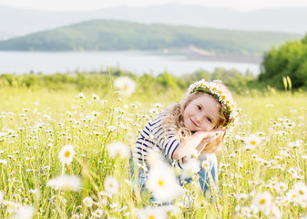 cute little girl in the chamomile field