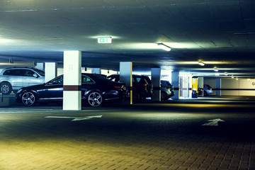 Underground car park with cars. Toned, filtered.