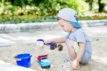 Toddler boy playing in the sand