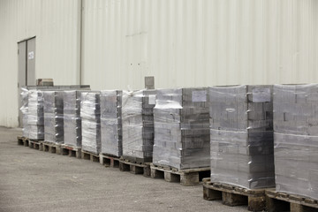 Cobblestone wrapped in plastic paving on wooden pallets