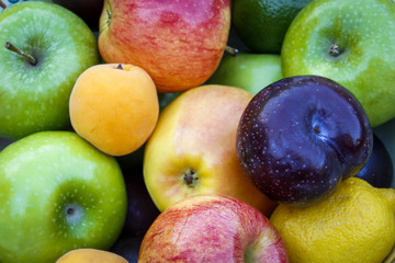 Mix of fruits and colours apples, plums and abricot