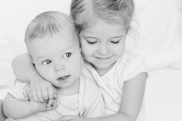 happy little sister hugging her brother