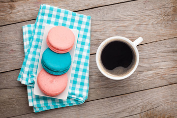 Colorful macaron cookies and cup of coffee