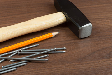 Hammer and nails on table