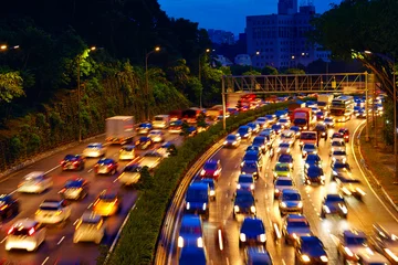 Fotobehang heavy traffic moving on the road in twilight, Kuala Lumpur © Olesia Bilkei