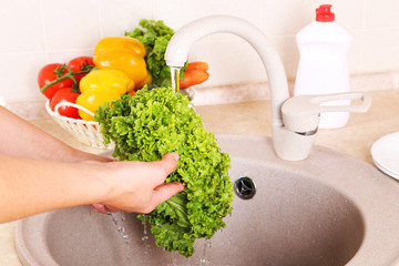 Vegetables washing in kitchen